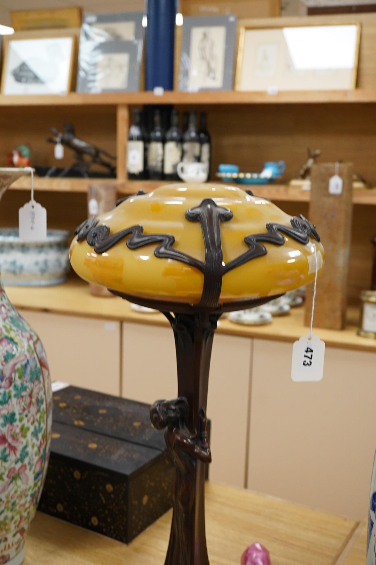 In the manner of Gustav Gurschner, an Art Nouveau style figural bronze lamp with yellow etched shade, 58cm